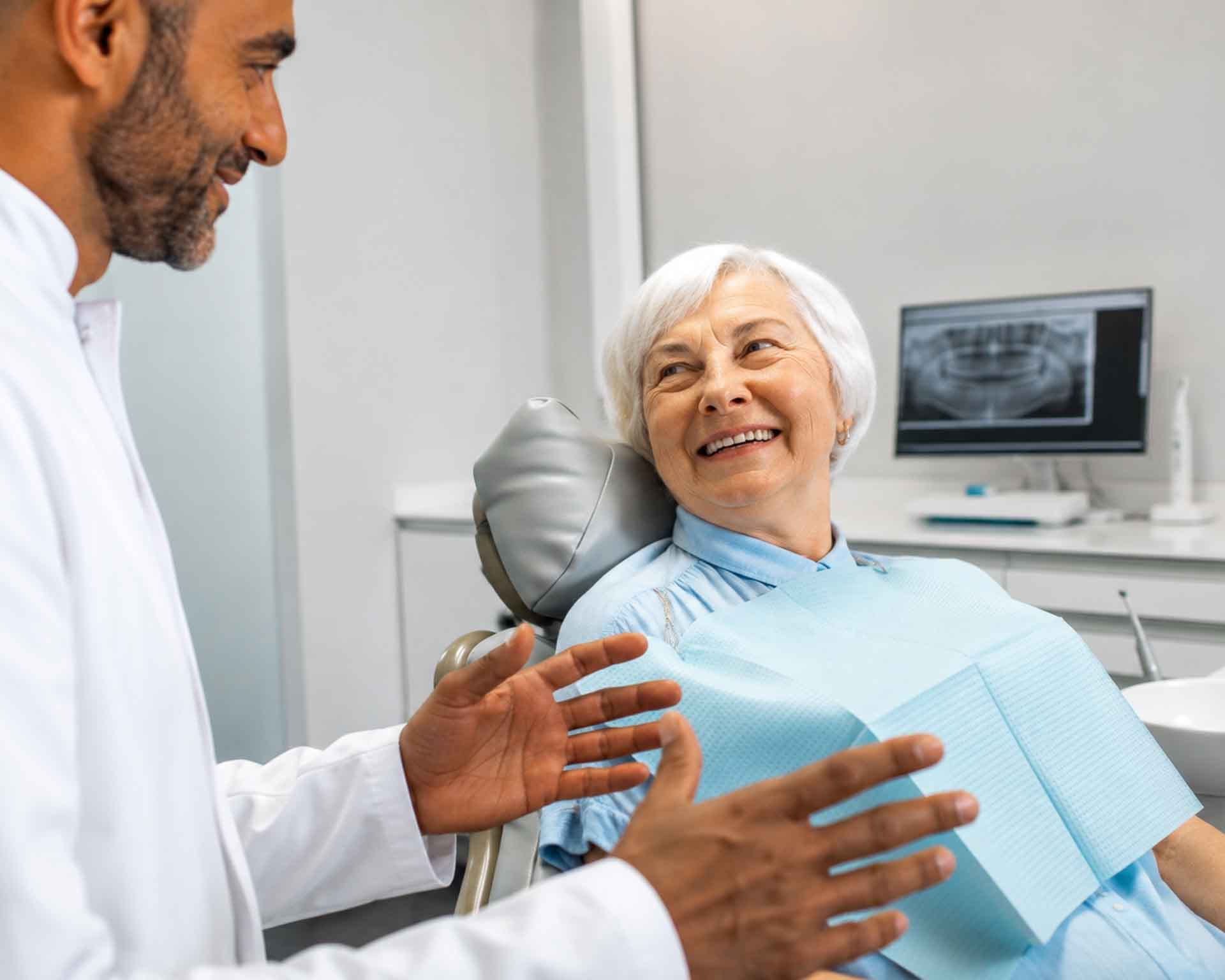 Older adult patient talking with a dentist at Grand Blanc Dental Center in Grand Blanc, Michigan